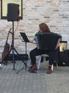 London accordionist Aine McLoughlin practicing accordion in a studio setting.