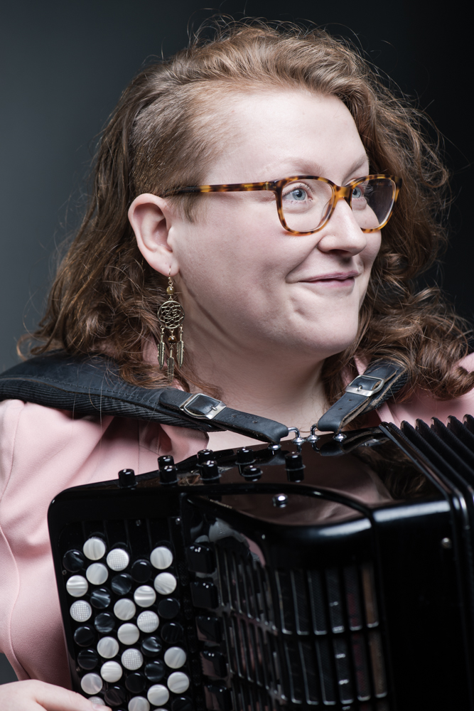 Close up shot of Aine McLoughlin, London-based accordionist, holding an accordion