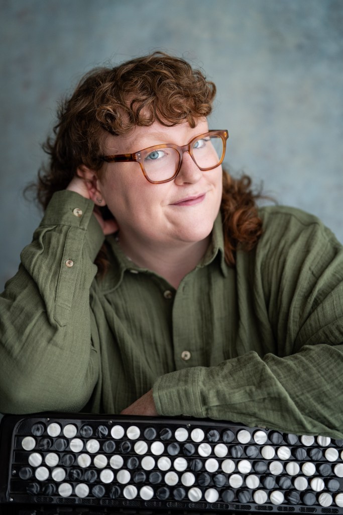 London-based accordion payer Aine McLoughlin in a green shirt - professional head shot